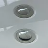 Close-up view of two chrome drains on a white surface, likely a bathtub. Produktbild-Vorschau