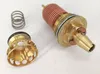 A disassembled plumbing valve component and a spring are laid out on a white surface. Produktbild-Vorschau