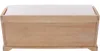 A light-colored wooden storage bench with a white cushion on top, shown from the front against a white background. Podgląd zdjęcia produktu