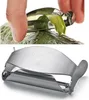 A hand is using a peeler to peel a cucumber. Anteprima dell’immagine prodotto