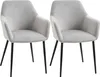 Two light gray upholstered chairs with black legs are shown against a white background.