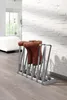 A boot rack with boots in it, placed on a wooden floor next to a white wall. Produktbild-Vorschau