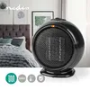 A black ceramic fan heater is shown in a bedroom setting, placed on a white surface. The background includes a bed with pillows and a blanket, and framed artwork on the wall. Anteprima dell’immagine prodotto