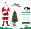 A Christmas scene featuring Santa Claus, a decorated Christmas tree in a pot, and product feature callouts. Podgląd zdjęcia produktu
