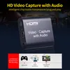 A close-up marketing image of a black HD video capture device with text overlays and icons at the bottom. Produktbild-Vorschau