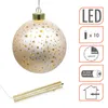 A decorative LED Christmas ball ornament with a star pattern, shown with its battery pack and informational graphics. Náhled obrázku produktu