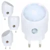 A group of white LED night lights with plugs are arranged on a white background. Anteprima dell’immagine prodotto