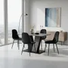 A dining room set with a table and four chairs, set in a modern, well-lit room with a large window and artwork on the wall. Produktbild-Vorschau