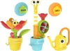 A set of colorful Yookidoo bath toys, including a snail-shaped water toy, a flower-shaped toy with a bee, and a small watering can. Podgląd zdjęcia produktu