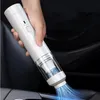 A hand holding a white portable vacuum cleaner inside a car. Produktbild-Vorschau