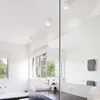 A modern bathroom with a bathtub, sink, and large mirror. Produktbild-Vorschau