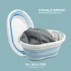 A collapsible laundry basket filled with clothes, shown against a light blue background. Produktbild-Vorschau