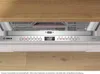 Close-up of a dishwasher control panel with a digital display and various buttons, set within a kitchen environment with wooden cabinets. Produktbild-Vorschau