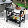 An outdoor patio setting with a grill cart filled with items like wine bottles, snacks, and utensils. Produktbild-Vorschau