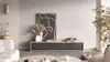 A modern living room scene featuring a TV stand with a turntable and artwork. Náhled obrázku produktu