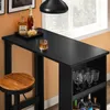 A black bar table with a wooden stool and bottles of alcohol on top, set against an orange wall and a window. Produktbild-Vorschau