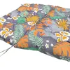 A close-up view of a colorful, tufted cushion with a tropical leaf and flower pattern. Voir les images du produit