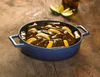 A blue pot filled with stuffed grape leaves and lemon slices, placed on a wooden surface. Náhľad obrázku produktu