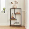 A black metal shelf unit with wood-look shelves, decorated with vases and books. Produktbild-Vorschau