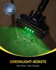 A vacuum cleaner head with green LED lights illuminating dust and debris on a wooden floor. Produktbild-Vorschau