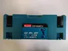 A teal-colored plastic case for a power tool, with branding and product information visible on the front. Náhľad obrázku produktu