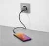 A smartphone is charging from a wall outlet. Produktbild-Vorschau