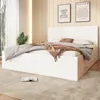 A bedroom scene with a bed, bedding, and wall decor. Produktbild-Vorschau