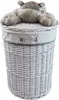 A white wicker laundry basket with a plush hippo toy on top. Produktbild-Vorschau