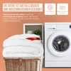 A folded white blanket is placed in a wicker basket next to a washing machine, with informational text and icons in the background. Produktbild-Vorschau