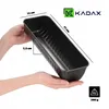 Hands holding a black loaf pan with dimensions indicated by lines and text. Podgląd zdjęcia produktu