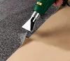 A heat gun is being used to lift a layer of material from a backing. Produktbild-Vorschau