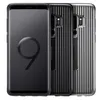 Three black Samsung phone cases are displayed side-by-side against a white background. The case on the left is a front view, showing the screen with a large '9' graphic. The two cases on the right are back views, showcasing a ribbed texture and the camera  Produktbild-Vorschau