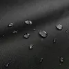 Close-up of water droplets on a black textured fabric. Náhled obrázku produktu