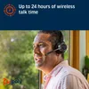 A man wearing a headset is looking out a window. Voir les images du produit