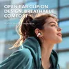 A woman wearing earbuds outdoors. Voir les images du produit