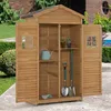 An open wooden garden shed filled with gardening tools. Produktbild-Vorschau