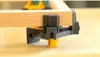 A close-up shot of a corner clamp holding two pieces of wood together. Produktbild-Vorschau