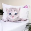 A close-up of a kitten's face printed on a pillowcase, lying on a white bed. Voir les images du produit