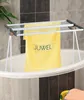 A yellow towel with the brand name 'JUWEL' is hanging on a drying rack placed over a bathtub. Voir les images du produit