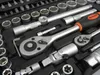 A close-up view of a tool kit with various sockets and ratchets. Podgląd zdjęcia produktu