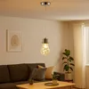 A living room scene with a pendant light hanging above a sofa and coffee table. Produktbild-Vorschau