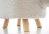 Close-up of the bottom part of a white, fluffy stool with four wooden legs. Produktbild-Vorschau