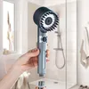 A hand holding a shower head with a detachable bottom part in a modern bathroom. Anteprima dell’immagine prodotto