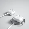 Two transparent protective cases for Apple AirPods are shown, one charging with a cable and the other on a wireless charging pad. Produktbild-Vorschau