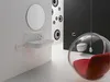 A modern bathroom with a sink, mirror, and a unique hanging bubble chair. Produktbild-Vorschau