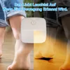 A product image showing a motion-activated LED night light with a split background illustrating its function. On the left, a child's legs are shown in normal lighting, and on the right, the same child's legs are illuminated by the warm light of the night l Produktbild-Vorschau