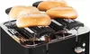 A black toaster with four bread rolls on top. Produktbild-Vorschau