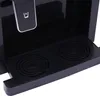 A close-up view of the lower section of a black water dispenser, showing the drip tray with two circular grates. Náhled obrázku produktu