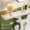 A close-up view of a white console table with decorative items and a lamp, set against a green wall. Anteprima dell’immagine prodotto