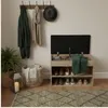 An entryway scene with a shoe cabinet, coat rack, and decorative items. Podgląd zdjęcia produktu